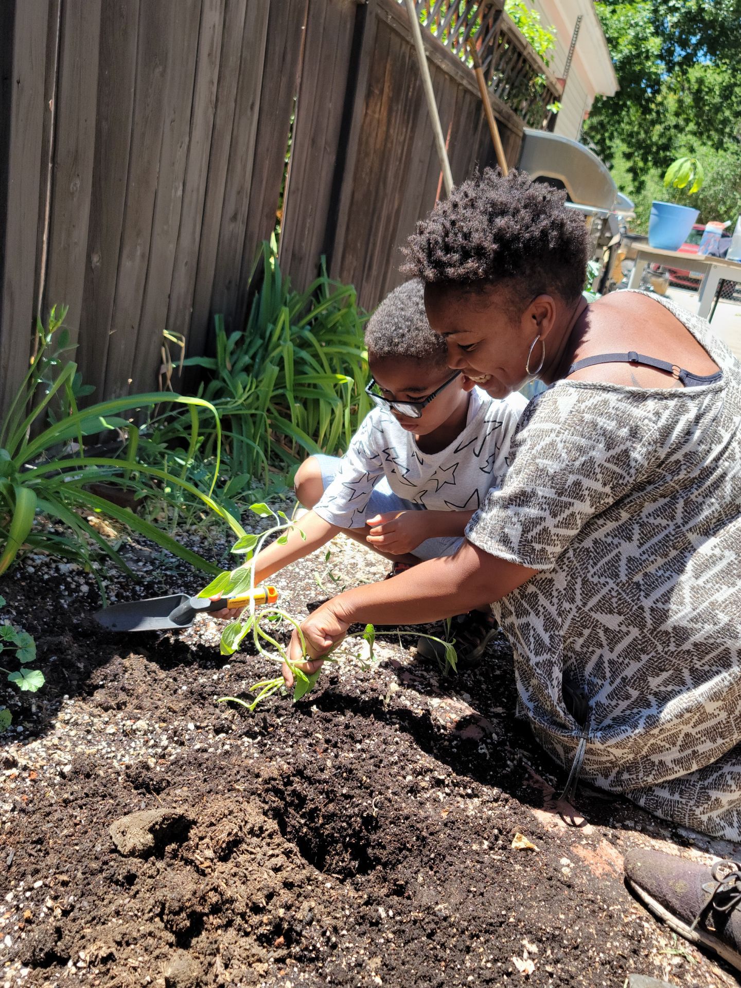 Woman and child planting together